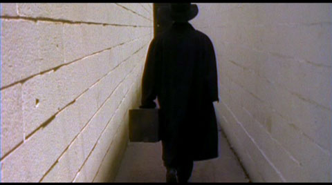 The man in black fled across the hallway, and the kickboxer followed.