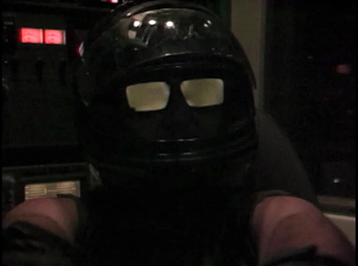 A motorcycle helmet. And sunglasses. To protect himself from the rigors of space. BUT NO SPACE SUIT, only a tank top.