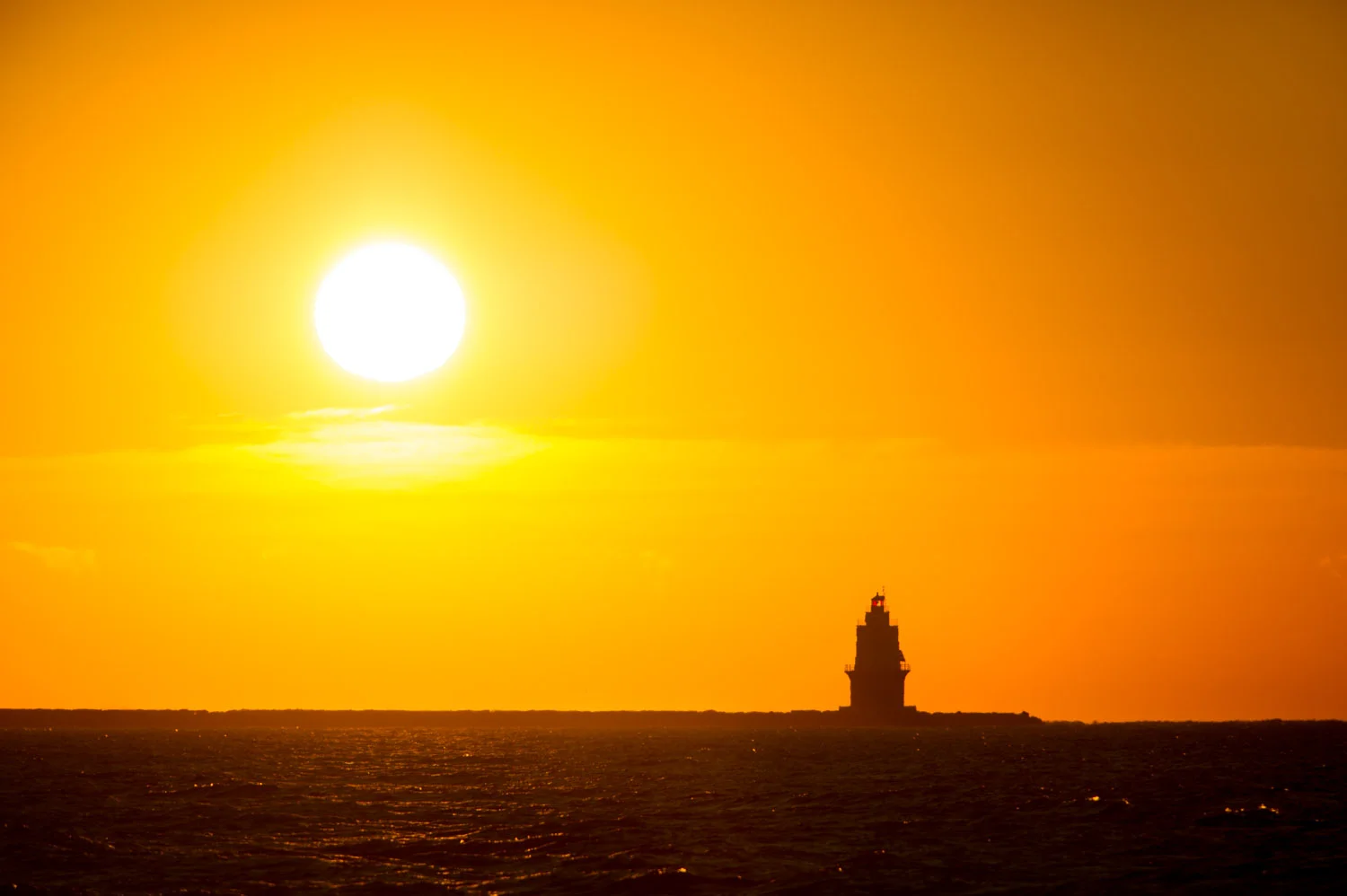 Sunrise behind the Harbor of Refuge Lighthouse as we leave Lewes Delaware in the morning.