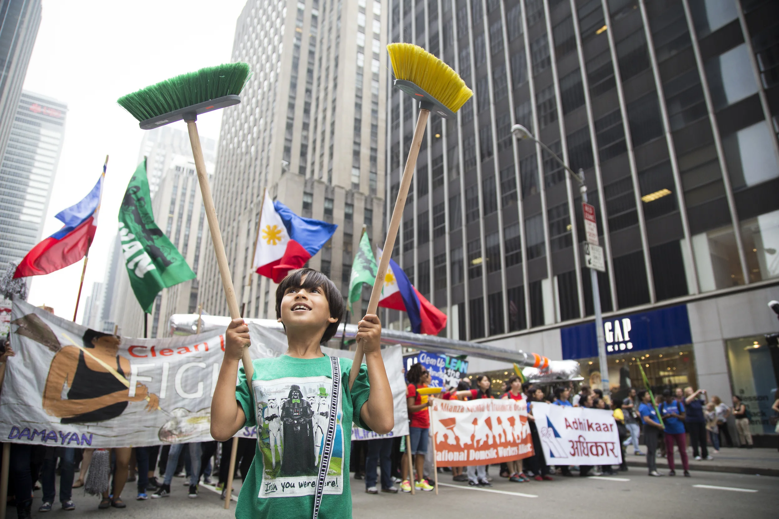Noah Crev, 7, chanting " Clean up the Mess." is the lead man for National Domestic Worker Alliance during Climate Change march in New York City on the 21st of September 2014. By Ann Wang