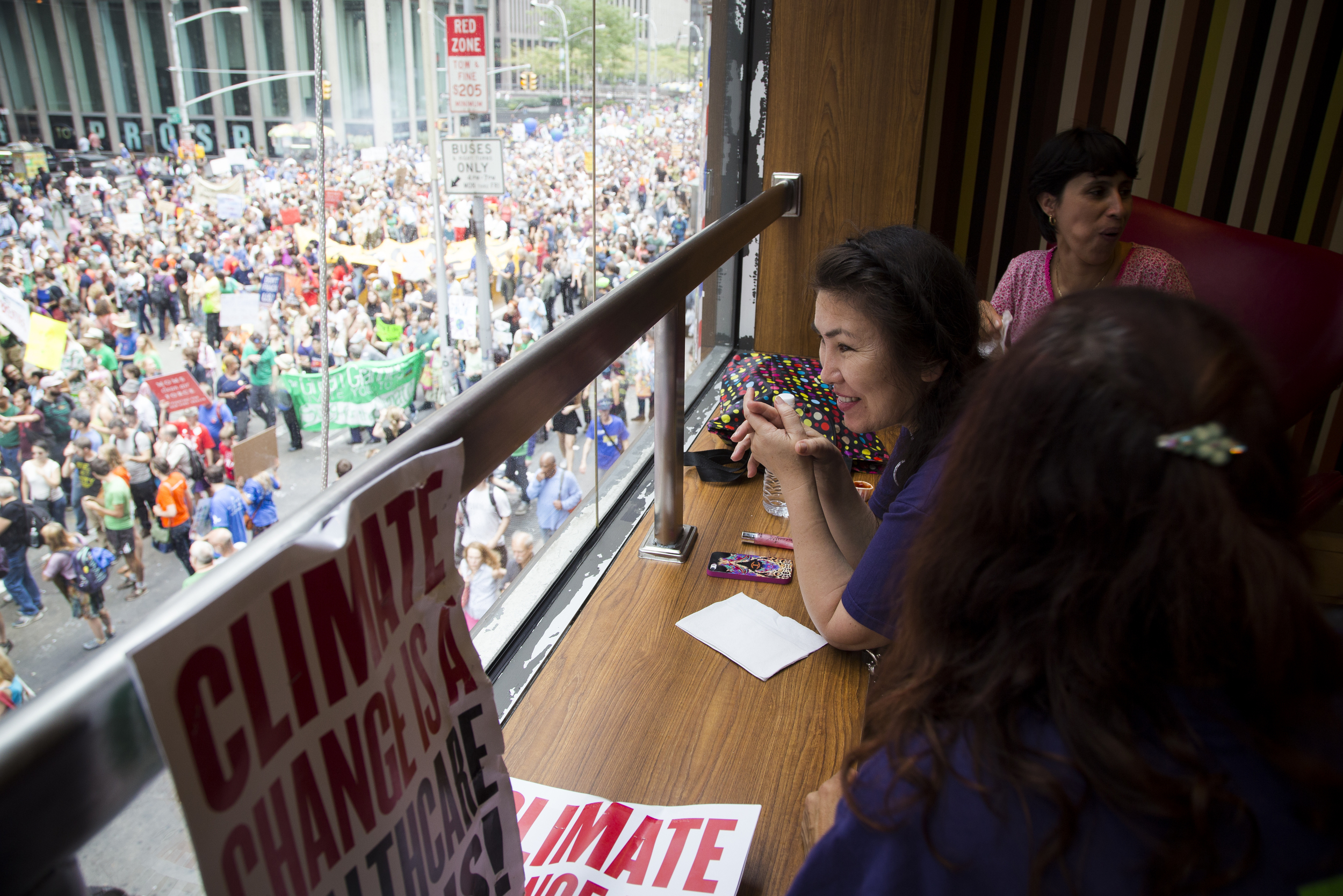 Elmira Muradova (M) and friends relaxing on the second floor of McDonald's while watching the Climate Change march in New York City. By Ann Wang
