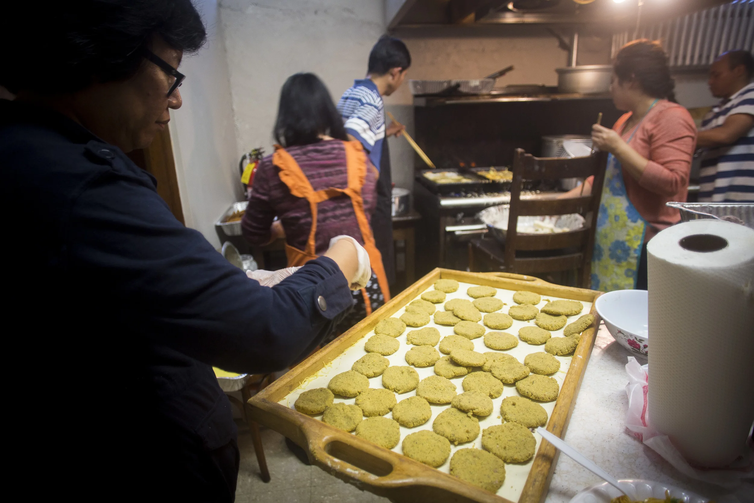 Preparing home-made authentic Burmese food at the kitchen in the basement of the International Community Church. By Ann Wang