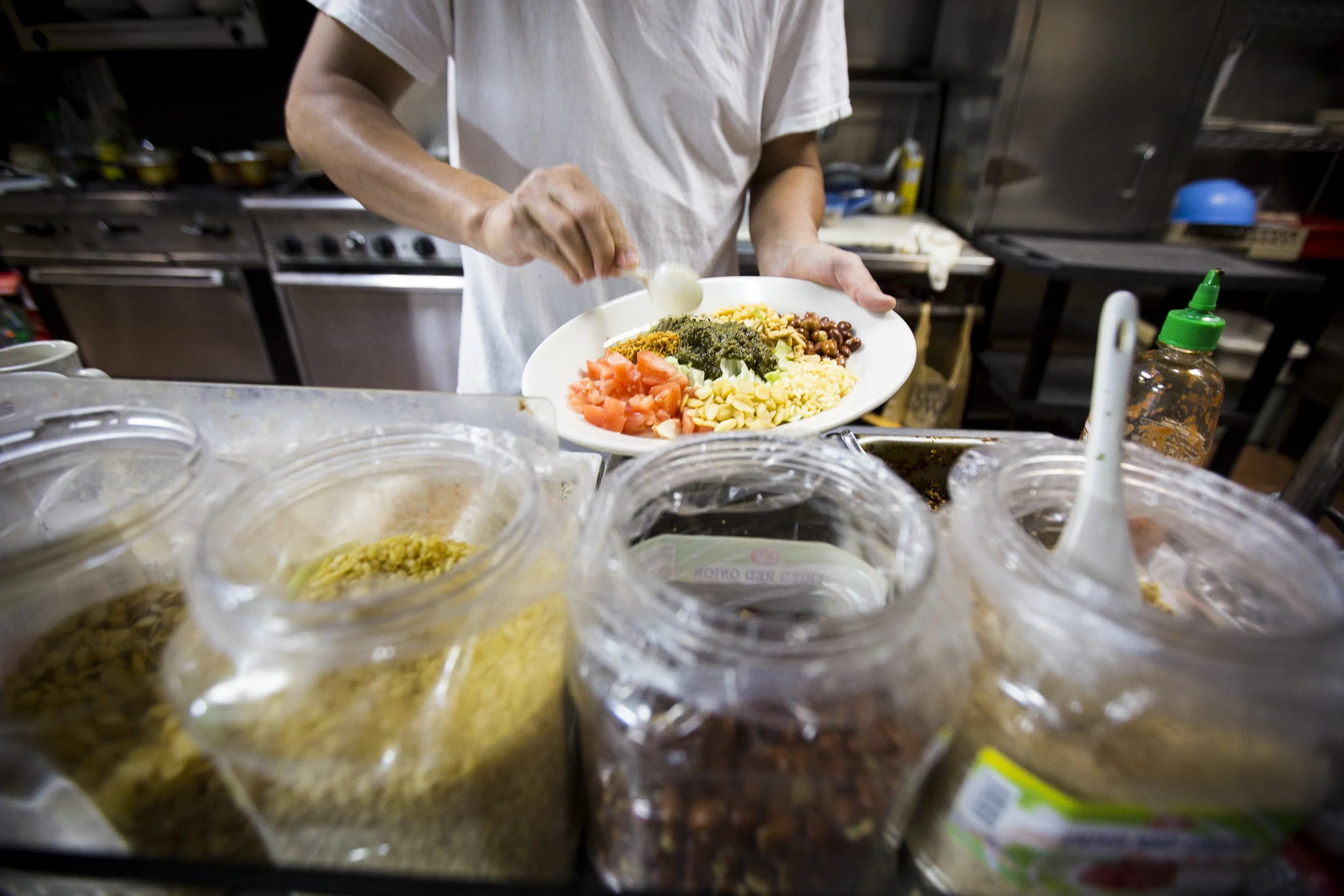  Owner and top chef of Yoma restaurant Sai Kyaw preparing tea salad in the kitchen.
By Ann Wang 