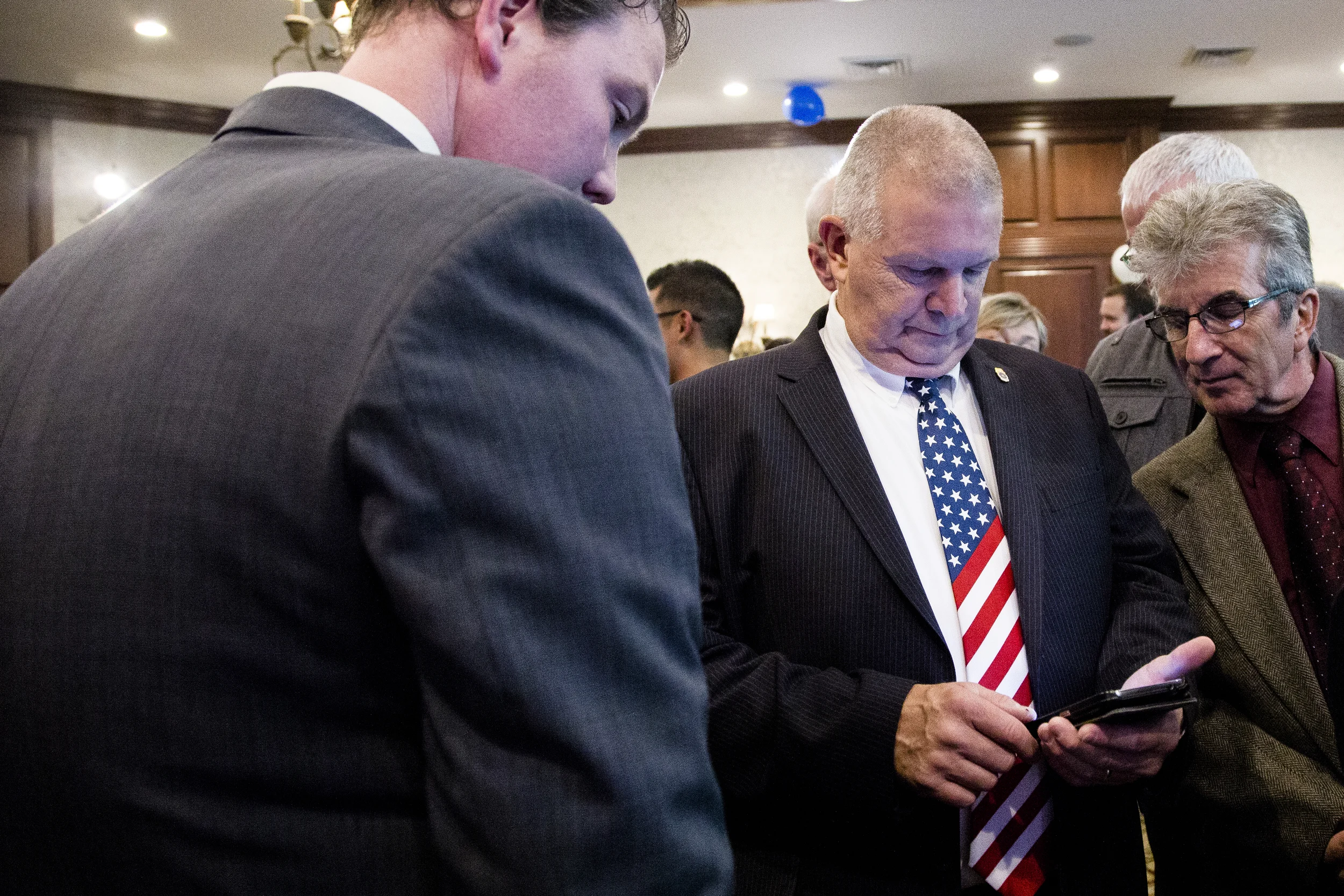 Manchester, NH, USA. Nov.4, 2014. Shaheen supporters checking their phone for the newest senate seat race updates. Photo Ann Wang