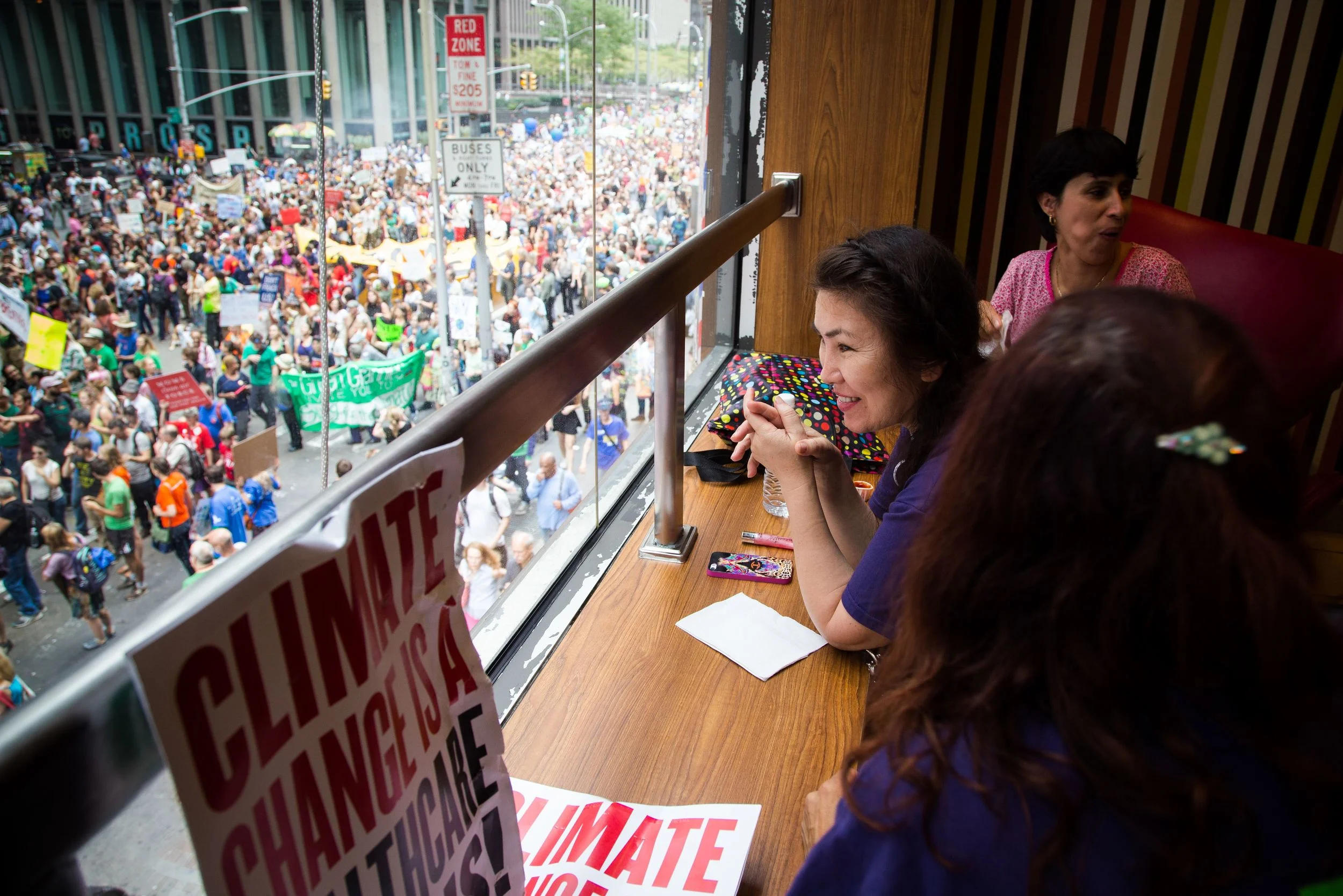 Elmira Muradova (M) and friends relaxing on the second floor of McDonald's while watching the Climate Change march in New York City. By Ann Wang