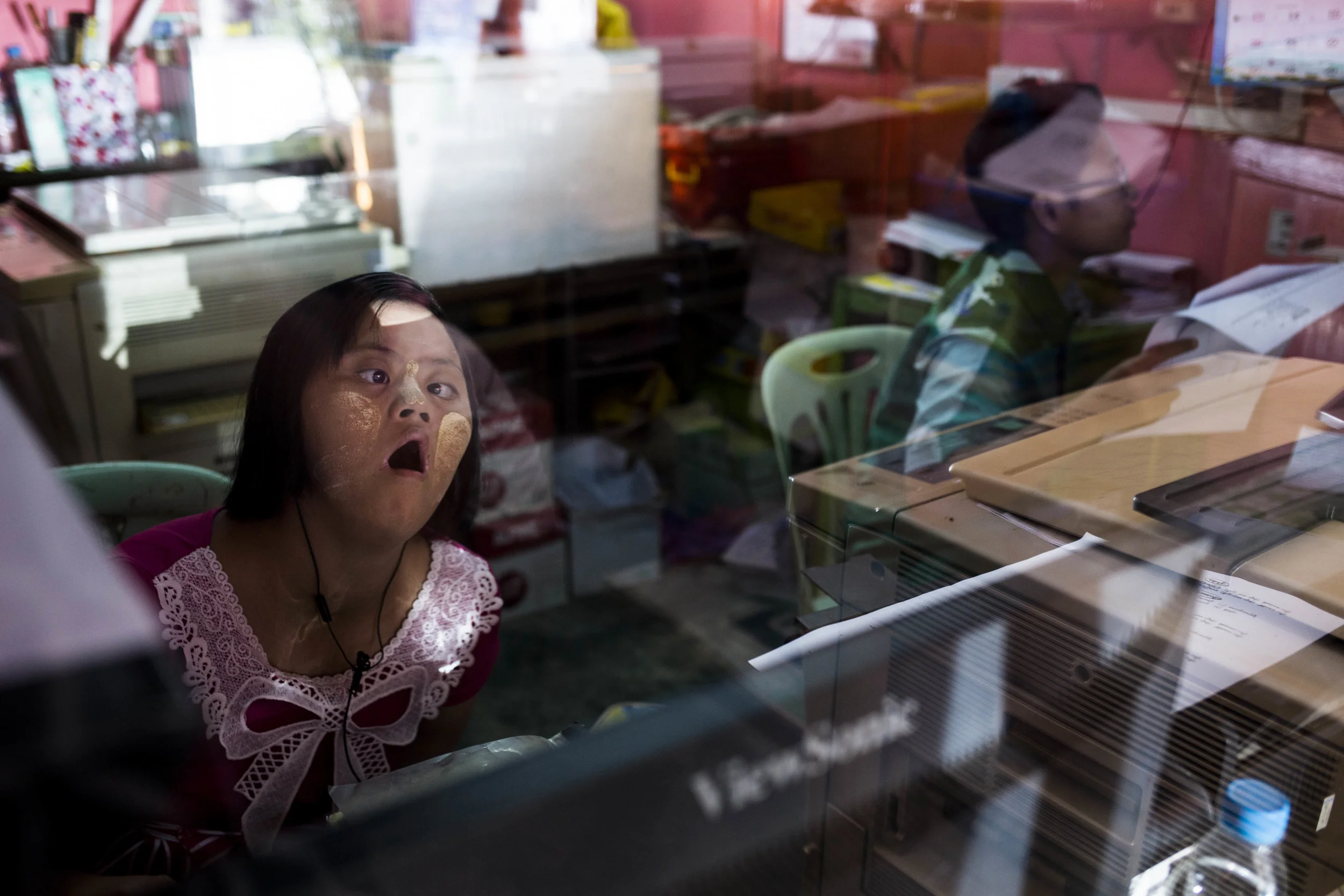 12.Theint Theint Thu has never attend school, but because she grew up in the family own printing shop. She knows how to type, but have trouble understanding the text and staying concentrated. Photo by Ann Wang
By following a couple of families with