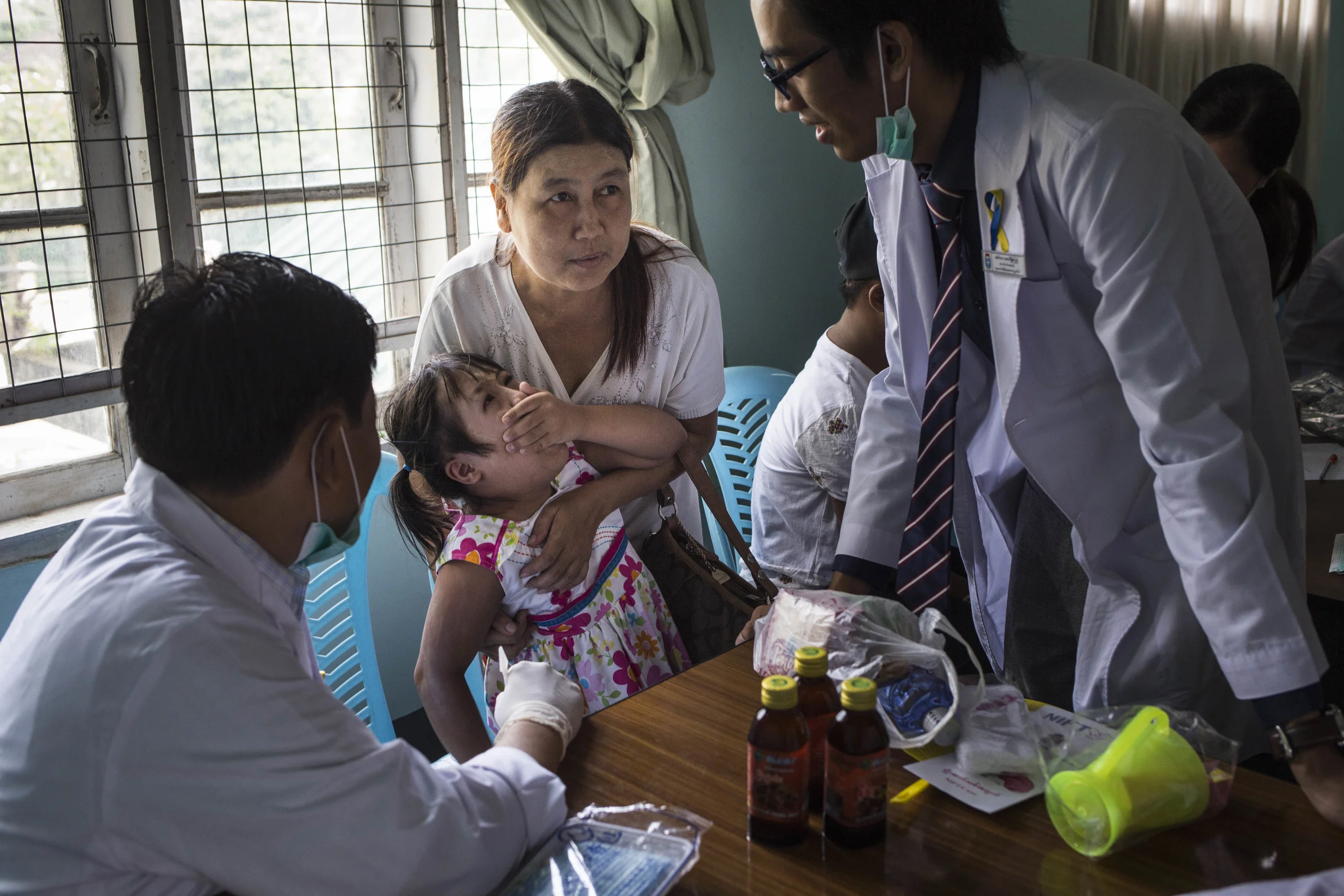 2.Due to the little understanding of Down Syndrome within the medical flied in Myanmar, the Myanmar Down Syndrome Association decided to partner with medical students and provide free dental care for more than 250 people with down Syndrome at Down Syndrome Day on October 25, 2015. For many families, it was their first time receiving dental care. Photo by Ann Wang
By following a couple of families with Down Syndrome children or adults, this project aim to show the limited resources these families have, which includes the county does not have facilities training special needs teacher, and discrimination against disable people, causing people with Down Syndrome in Myanmar rarely receives education. Yet, the families of the Down Syndrome children determent to make a change, with or without the help from the government.