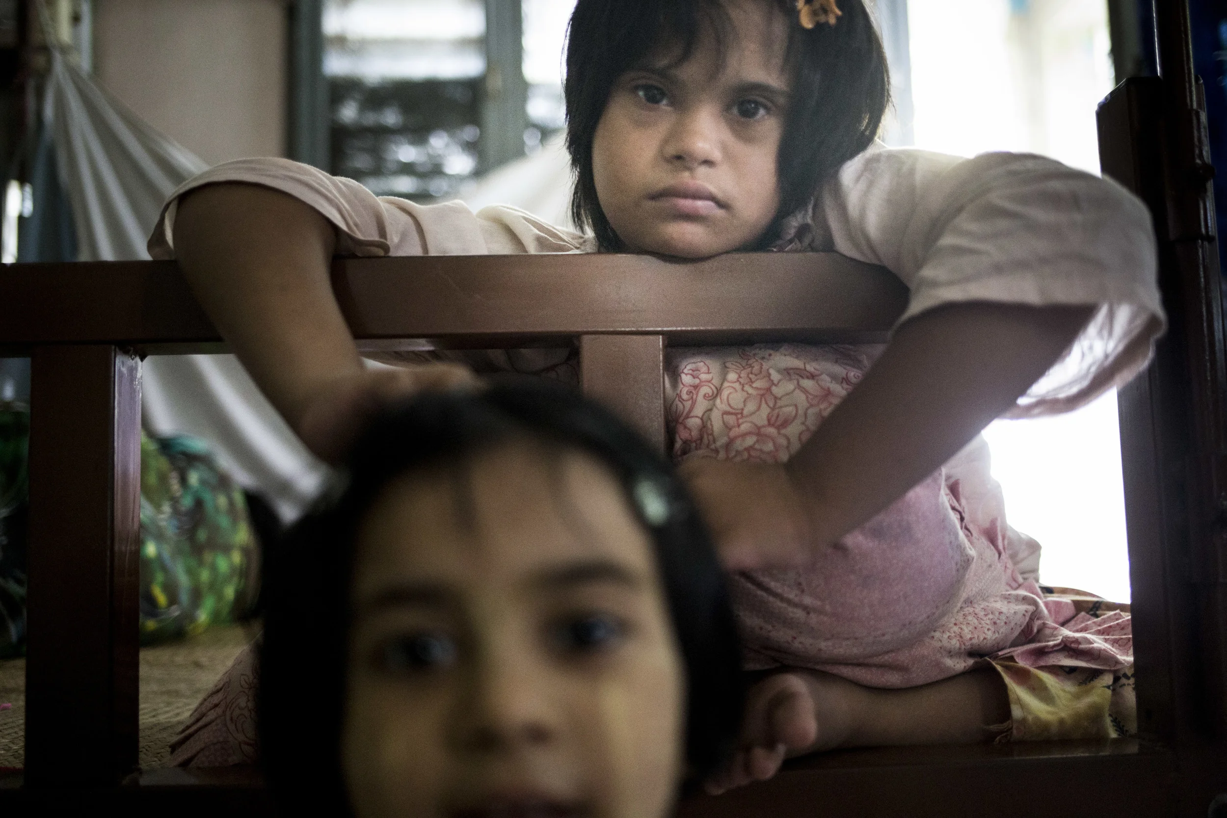Nay Chi is eight years older than her little sister Yait Su Wai. Her parents wants to make sure that they have an idea how to take care of Nay Chi who has down Syndrome before they want another kid. Photo by Ann Wang