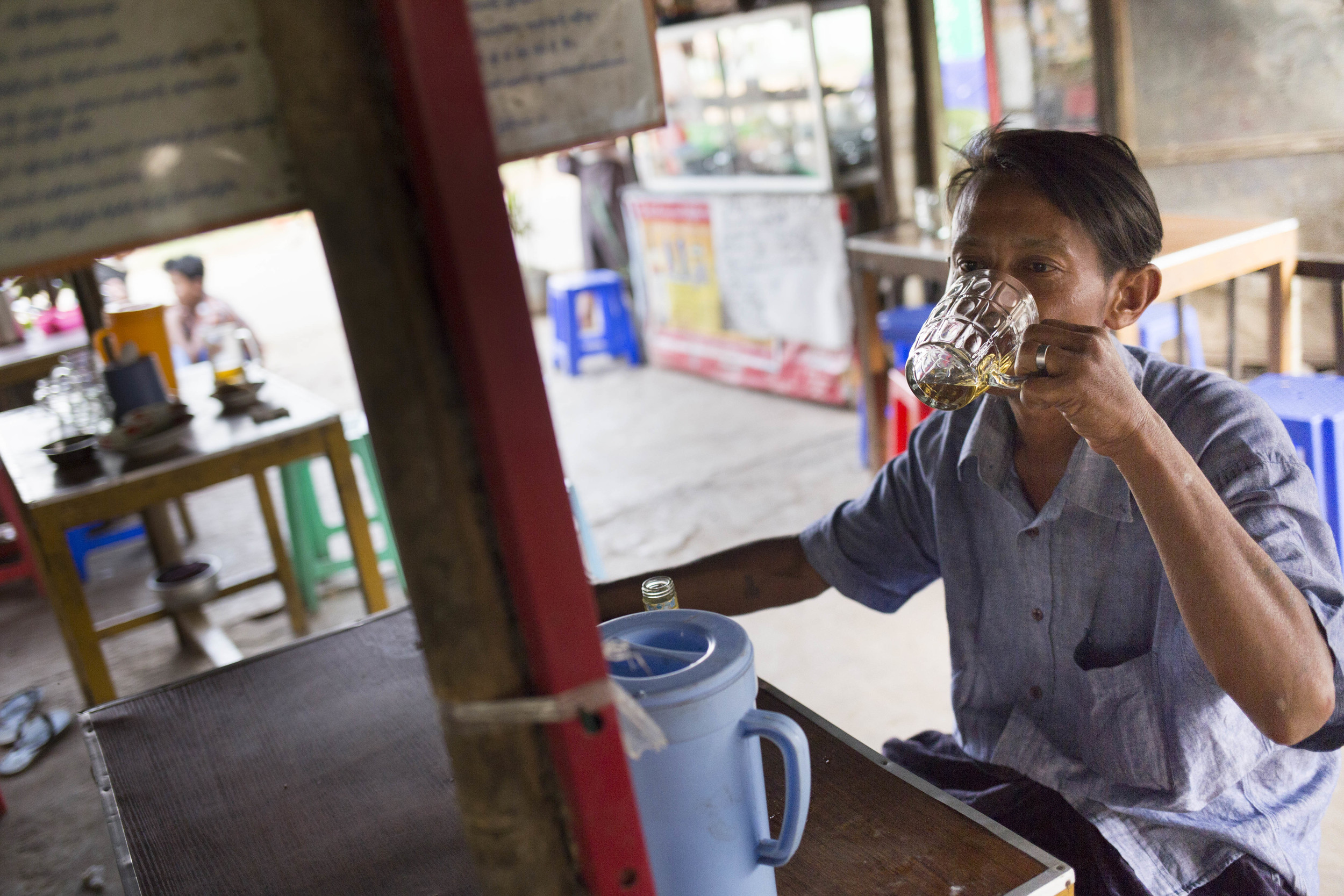  “I drink at least five bottles of whisky everyday,”said the drunk man at a local street side bar in South Dagon. Photo by Ann Wang 