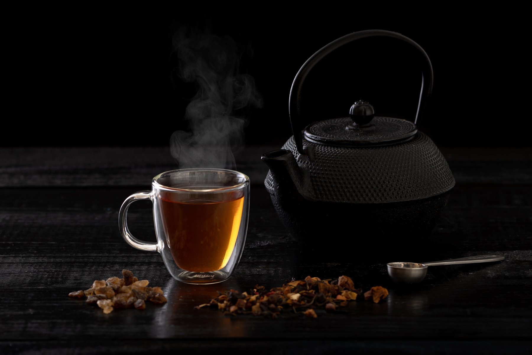 Black-Teapot-and-stimming-cup-of-tea-on-blackground.jpg