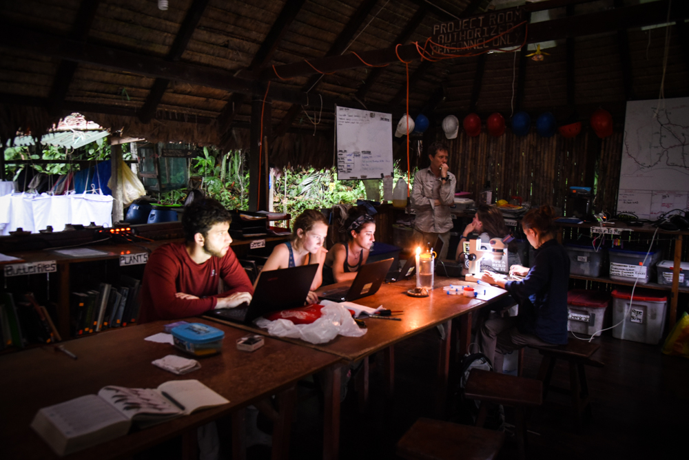  Night monkey researchers work on data analysis by candlelight at Manu Learning Centre.  