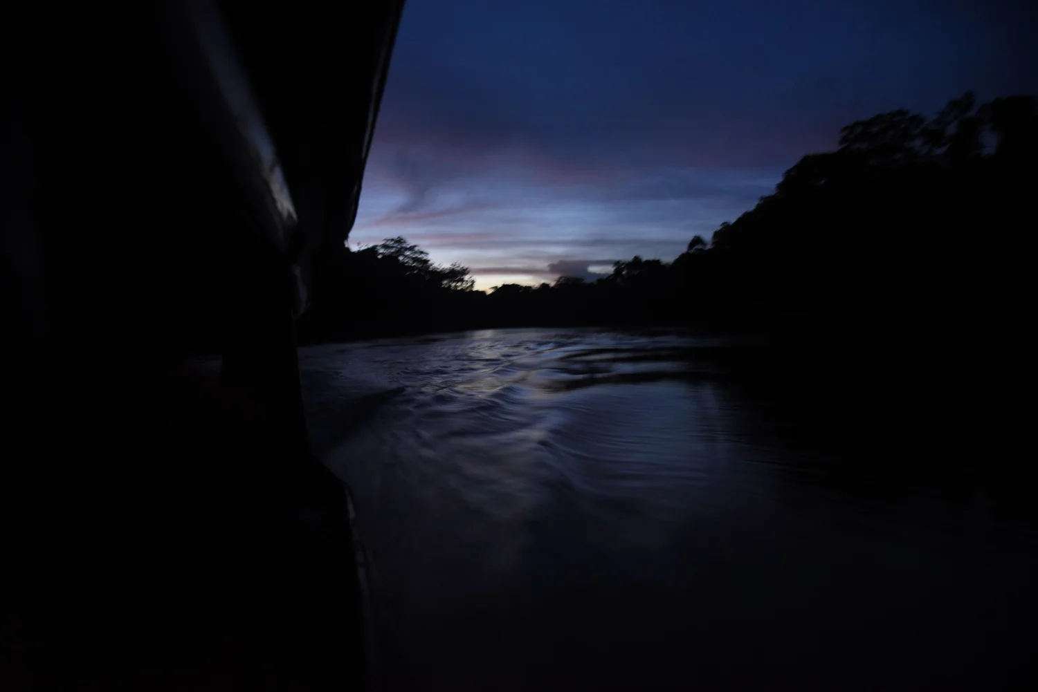  Boat driver, Manfred Cruz Zuvieta, navigates the last several hours of the journey to Pampas de Heath by night before arriving to camp across the river in Bolivia. 