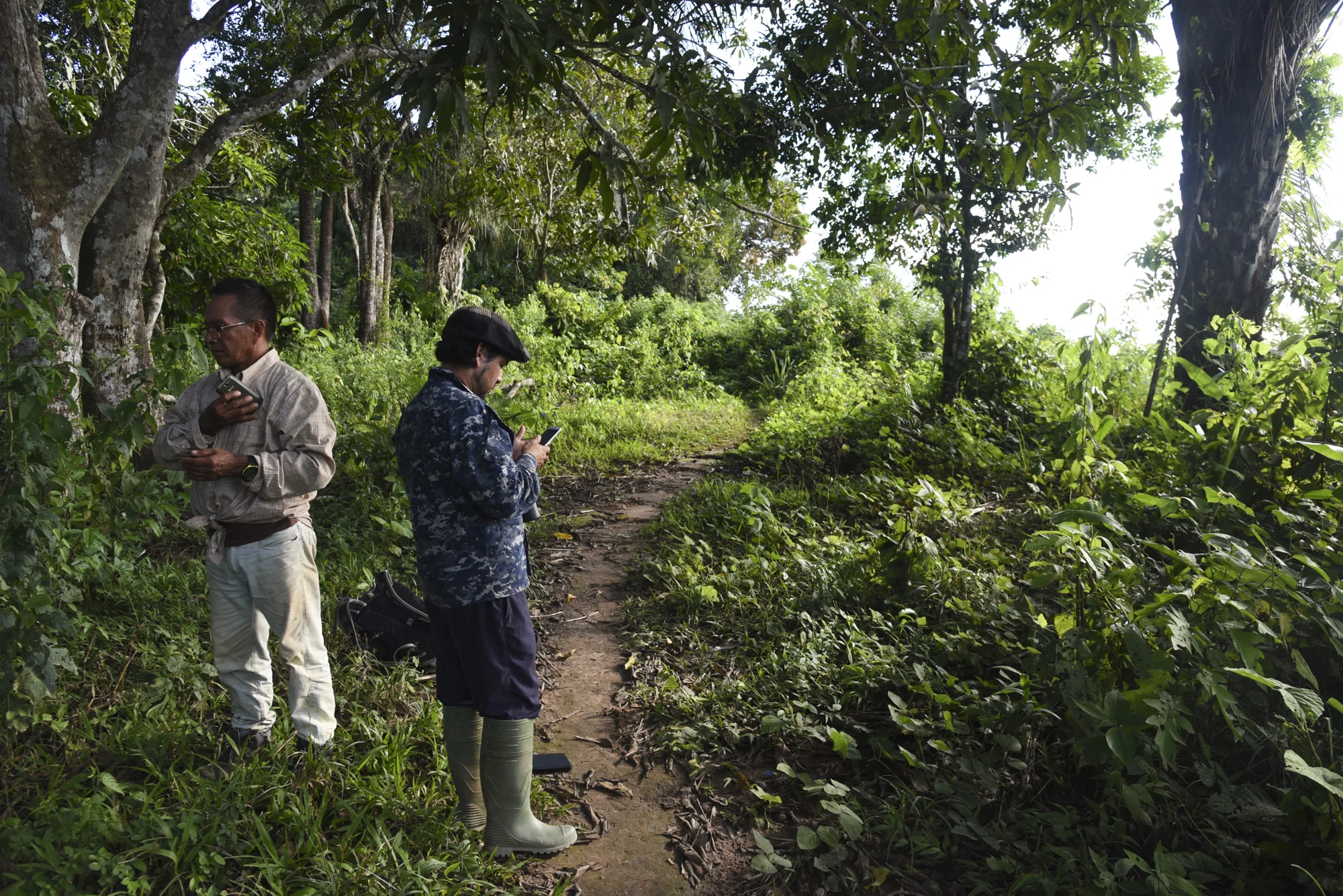  Manfred checks for cell phone signal while Yohamir finishes entering his Global Big Day results. 