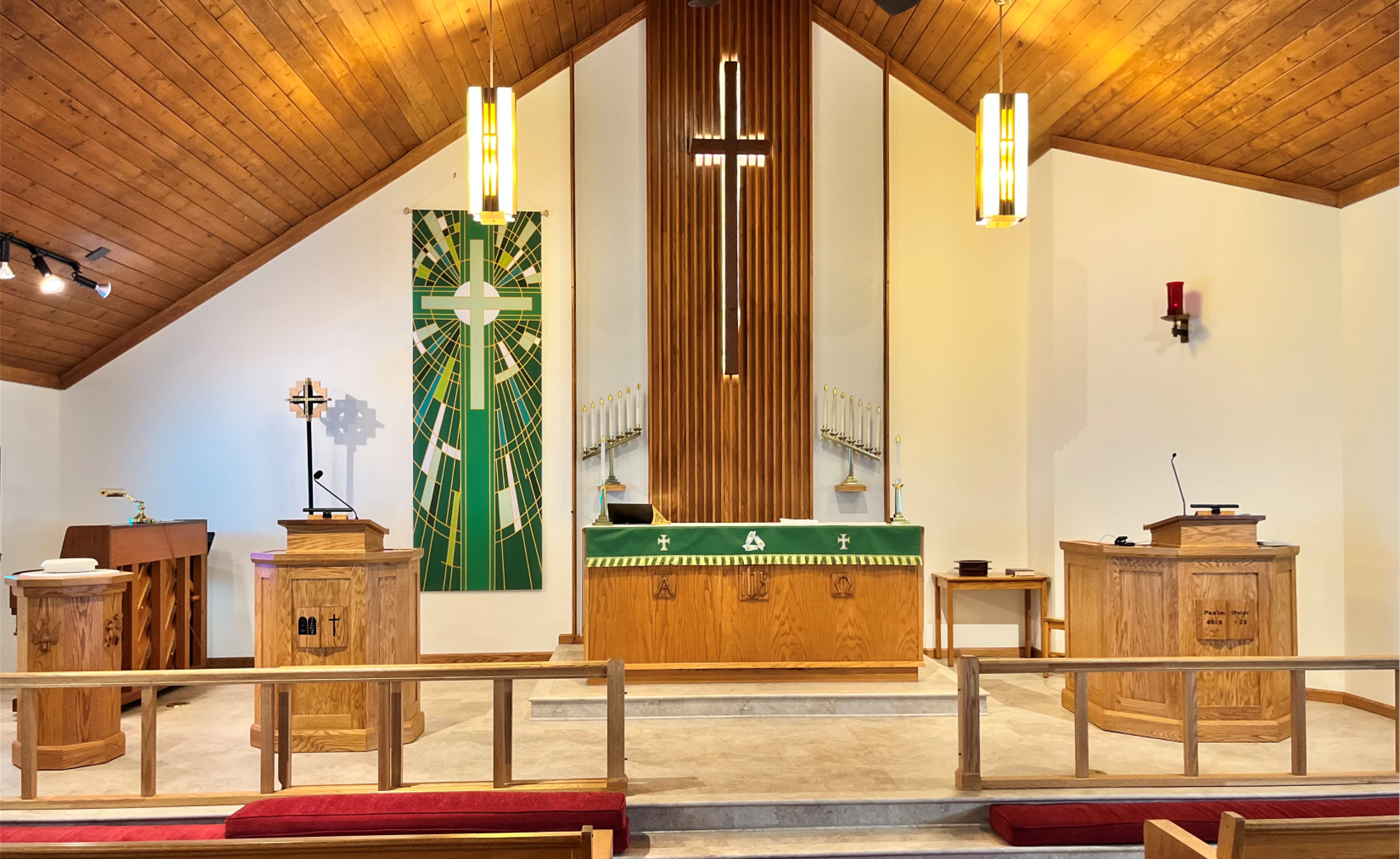 Interior of Christ Lutheran's sanctuary, showing altar, lectern, pulpit, and a large cross