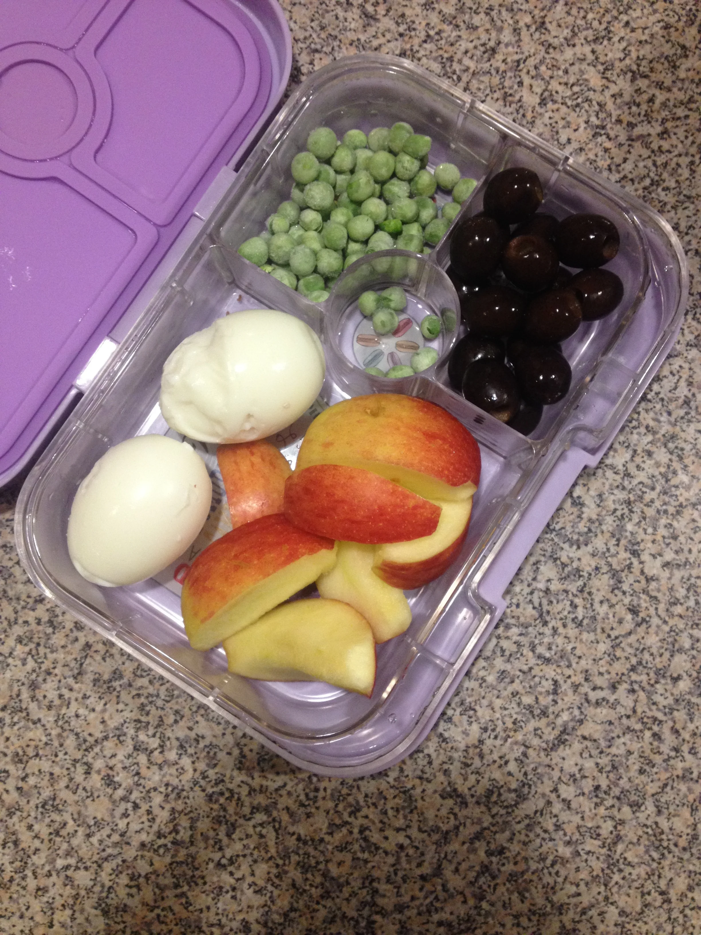 2 hard boiled eggs (she generally only eats the whites), apple, frozen peas, and black olives.