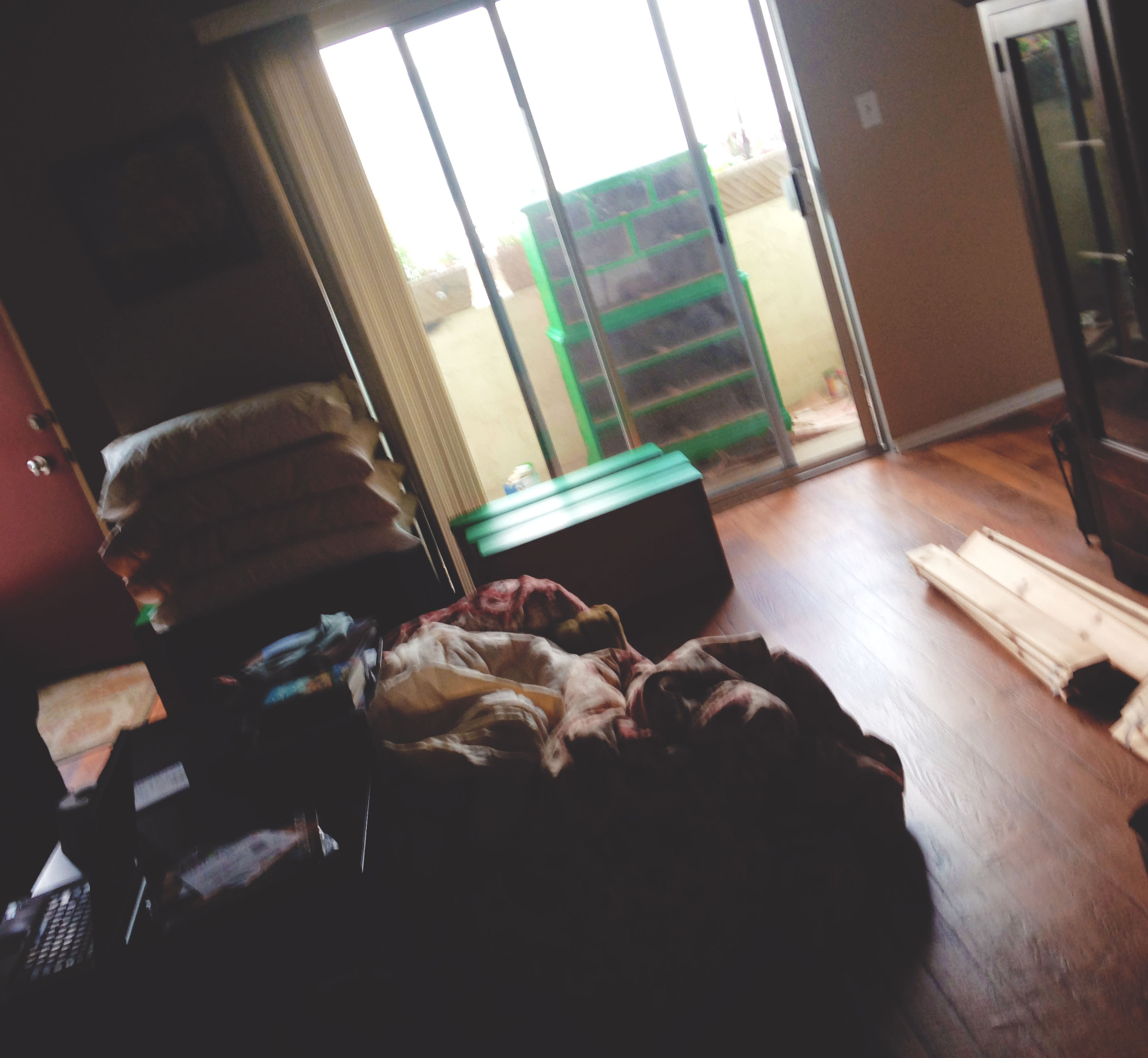 My living room and balcony in the process of painting the dresser and making over the bedroom