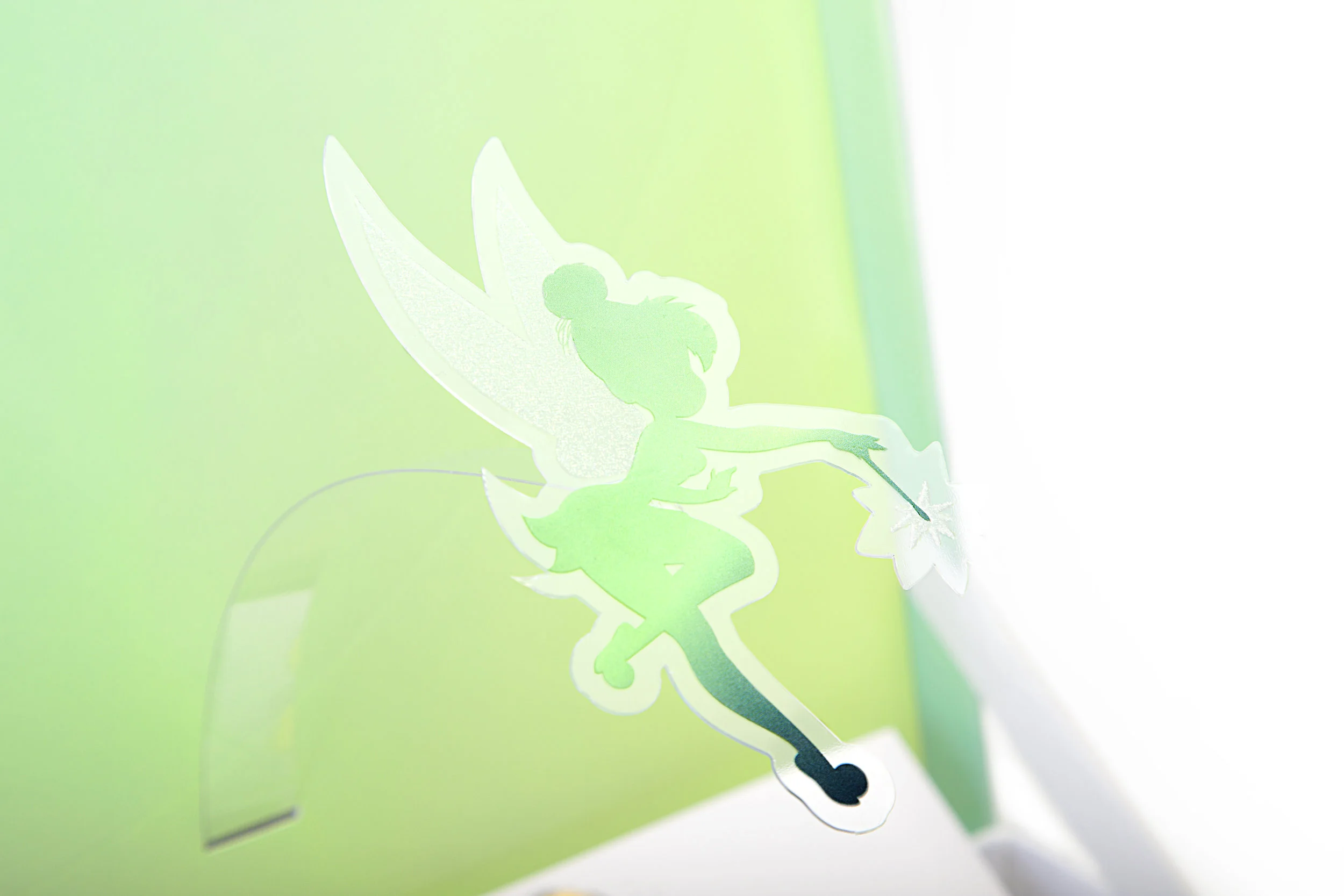 The package features a floating pop-up of Tinker Bell that hovers over the packaging when you open the box.