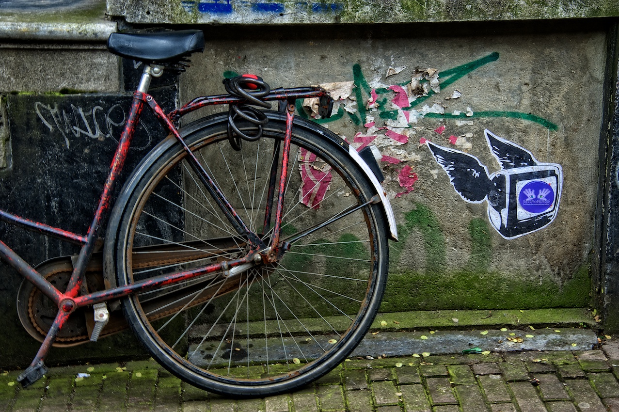 Just a bike leaning against a wall in some overlooked alleyway in Amsterdam...