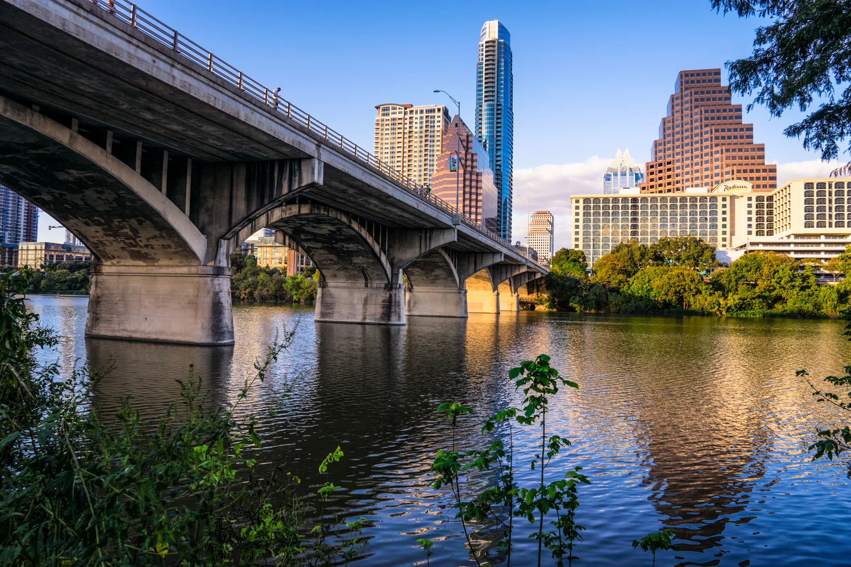 the congress avenue bridge with the austonian dominating the skyline