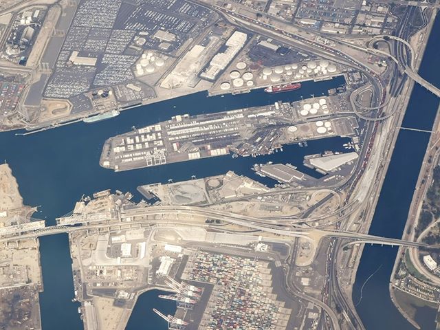 A (mostly) top down shot of some of the area around the Port of Long Beach, with a seemingly endless amount of shipping containers and other miscellany repetition. 
One of the interesting features here, the enormous parking lot at the top of the imag