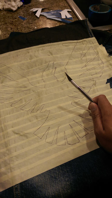 the masking tape stencil, ready to xacto the design out