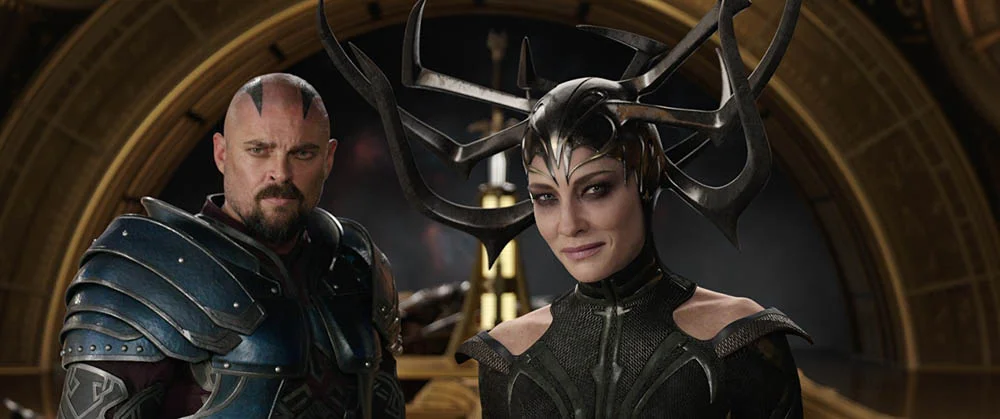 Skurge (Karl Urban) and Hela (Cate Blanchett)