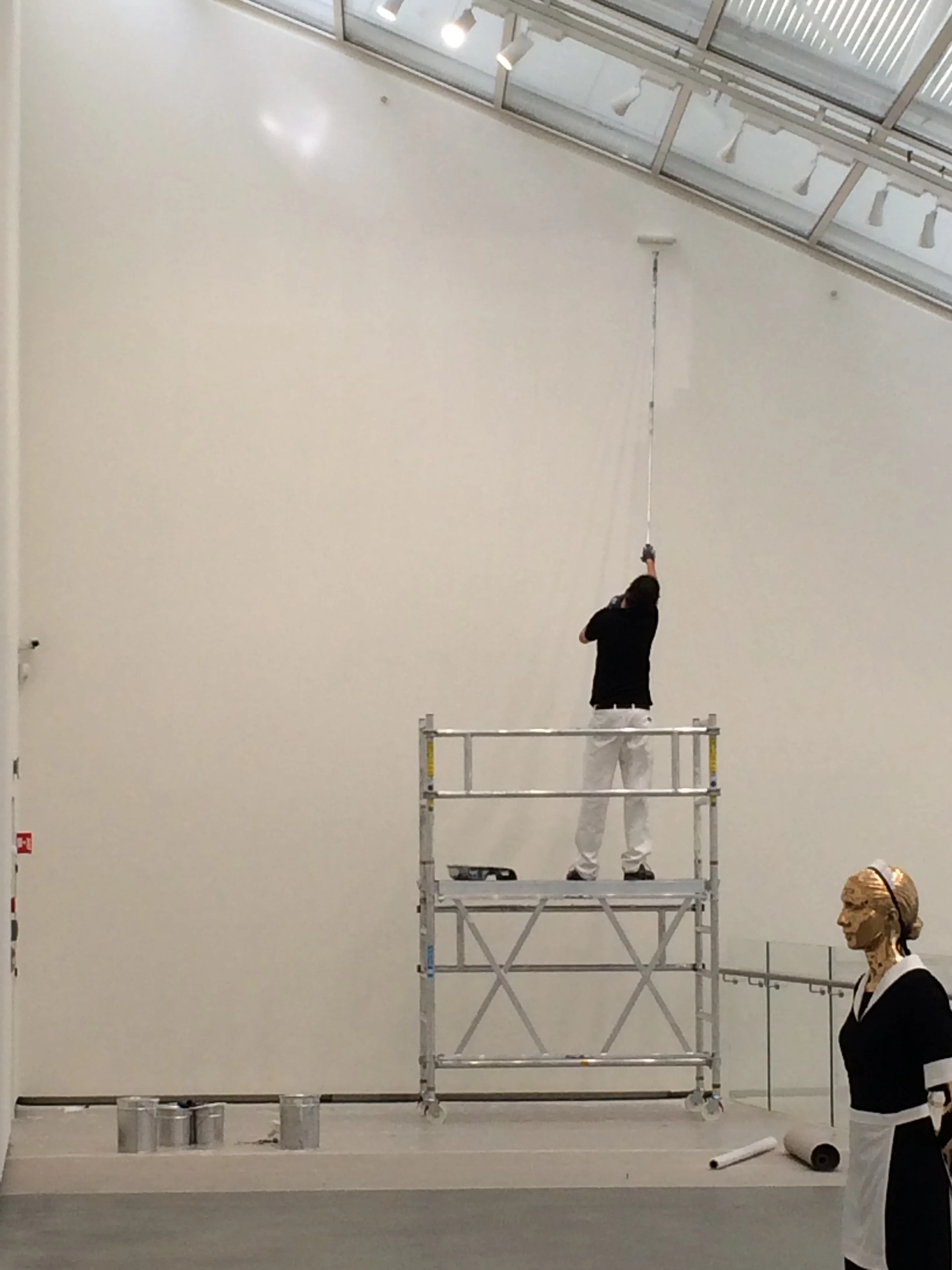 This guy was repeatedly painting the wall white as an "installation" or "performance".