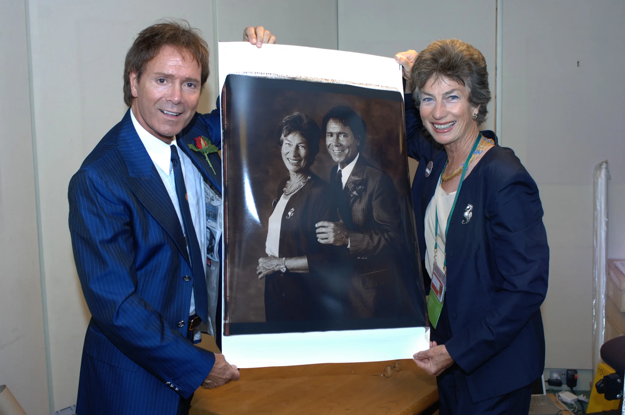 Cliff Richard and Virginia Wade attend the Royal Box at Centre Court and are overwhelmed by the size and detail of the Polaroid.