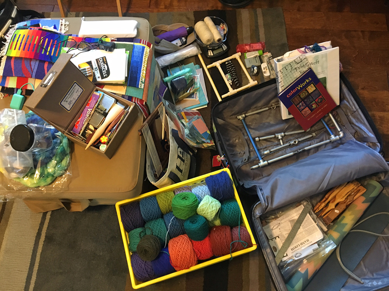 Yep, that is the pipe loom in the suitcase. Unless I change my mind (always a danger), I'm going to see if I can't do a couple four-selvedge pieces on this trip. Fingers crossed that TSA lets that one through! I will put the cones of warp in the oth…