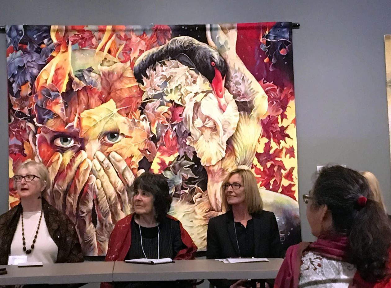 Linda Wallace, Barbara Heller, and Marie-Thumette Brichard participate in an artist panel. Tapestry behind them is Prelude to the Afternoon of a Faun by Gabriela Cristu.