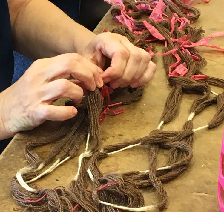 Dorina untying her ikat warp after dyeing it in black walnut. I believe it was also destined for the indigo pot.