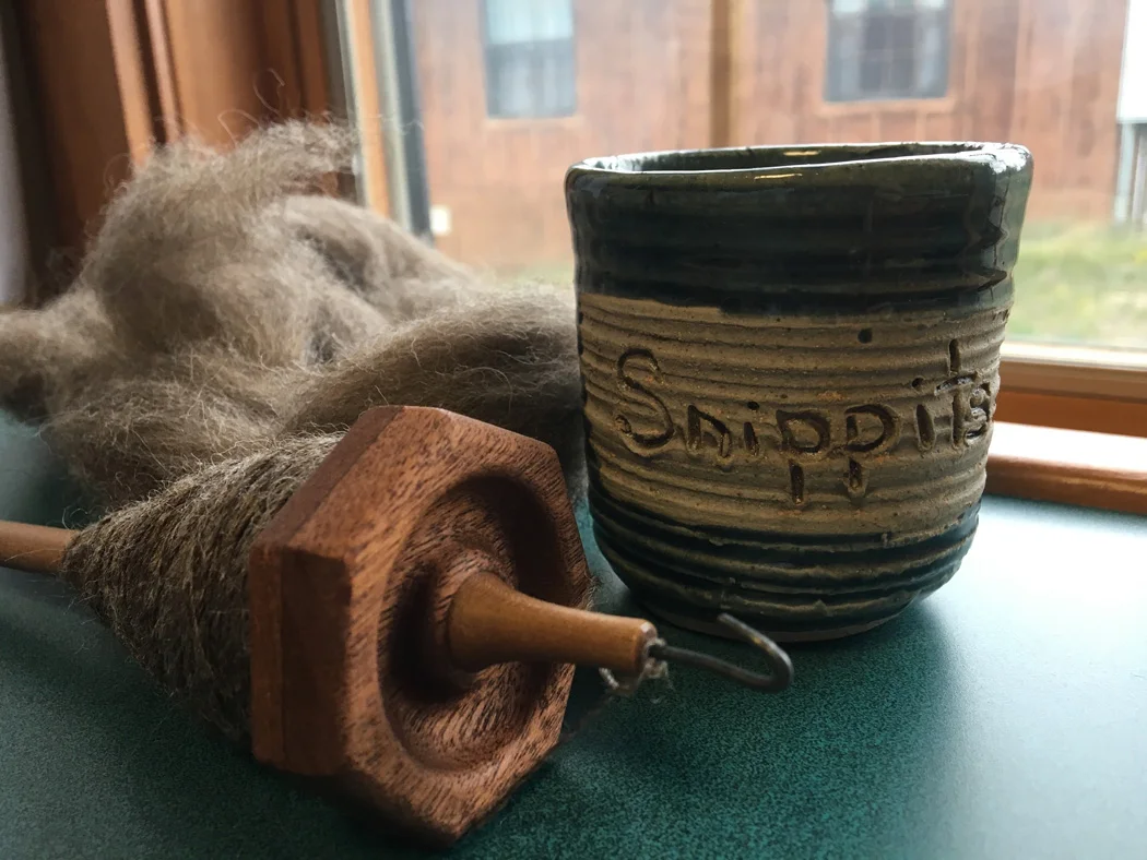 As seen in my cabin one morning... my Hepty spindle by Henry Edwards and my new yarn Snippits cup from Donna Wynn . Thanks Donna! One always needs a little place to put the yarn bits. It makes one's partner happy when they aren't always picking them up off the rug.