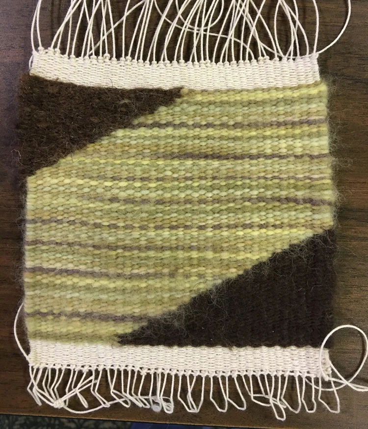 Sue spent some time playing with this marvelous variegated yarn and the different looks that are obtained with different kinds of yarns. These were all singles yarns and a lot of work was done trying to find the right color for that top corner that maintained the look of the singles. The plied yarns I had weren't right texture-wise, so she stuck with the single she had. She did further experimentation with a wonderful novelty yarn. I can't wait to see how that one turns out.