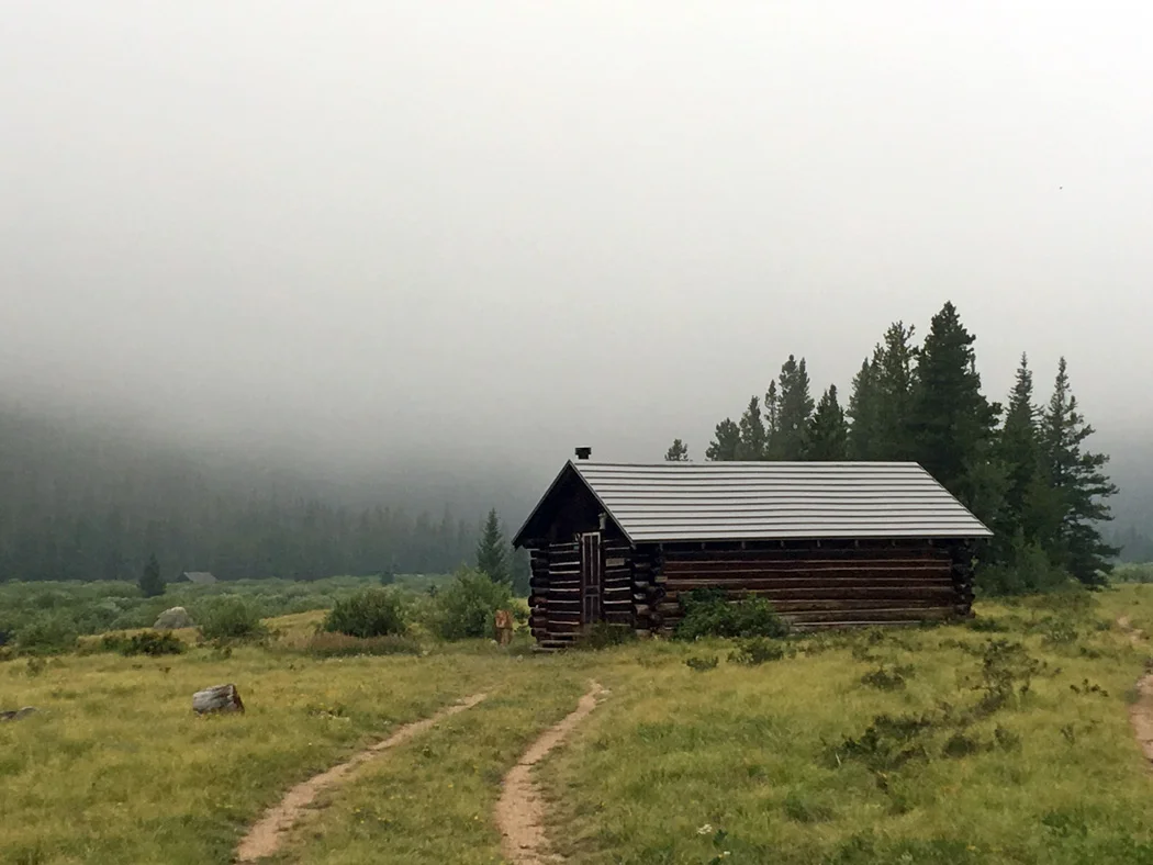 Fog obscuring the Mummy Range. Far cabin.