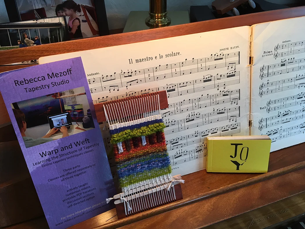Ellen Robertson, holiday weaving and piano duets with her family. JOY by Jilly Edwards, tapestry artist.