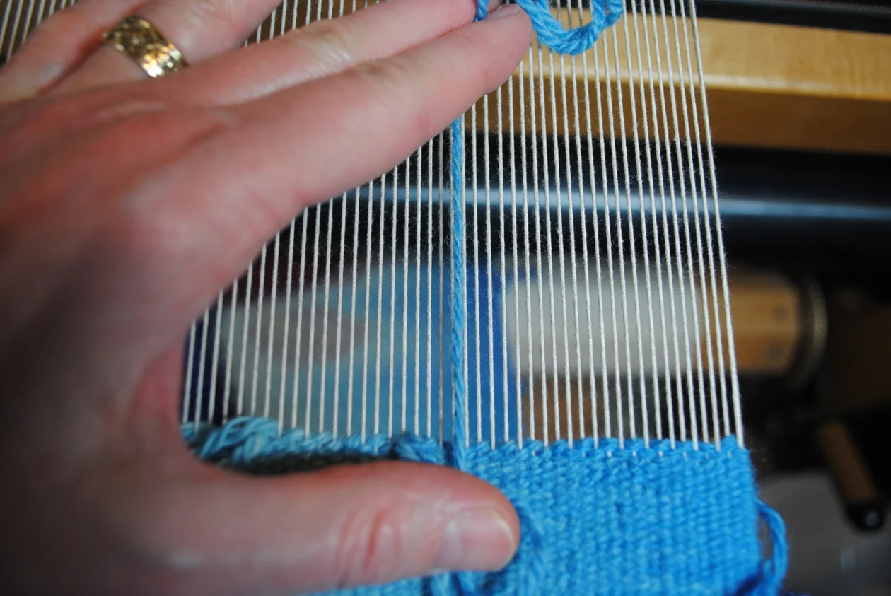 If you’re a particulars person: the above example is three strands of Harrisville Koehler Singles plied on a wheel and woven at 10 epi on 12/6 cotton seine twine on a countermarche Harrisville Rug Loom. Whew.