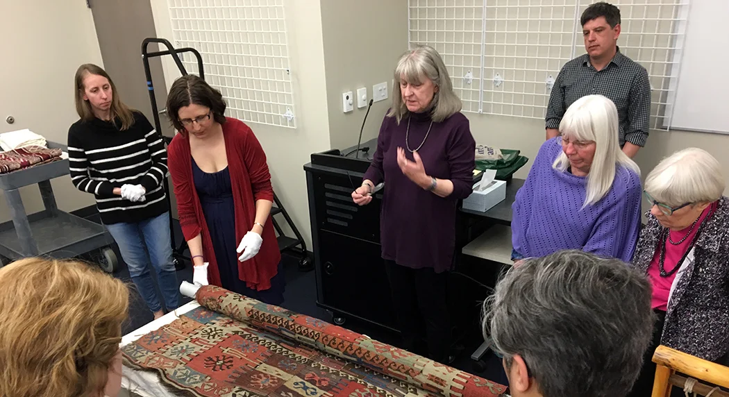 Susan Iverson talking about a kilim from N. Africa at the Avenir Museum