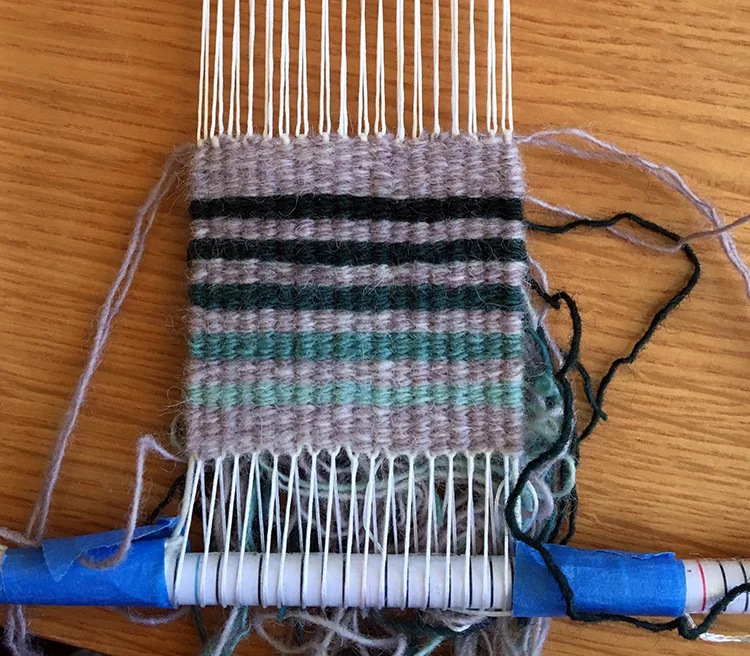 Four selvedge on Brown Sheep warp. That lavender background color is the SAME throughout! 8 epi.