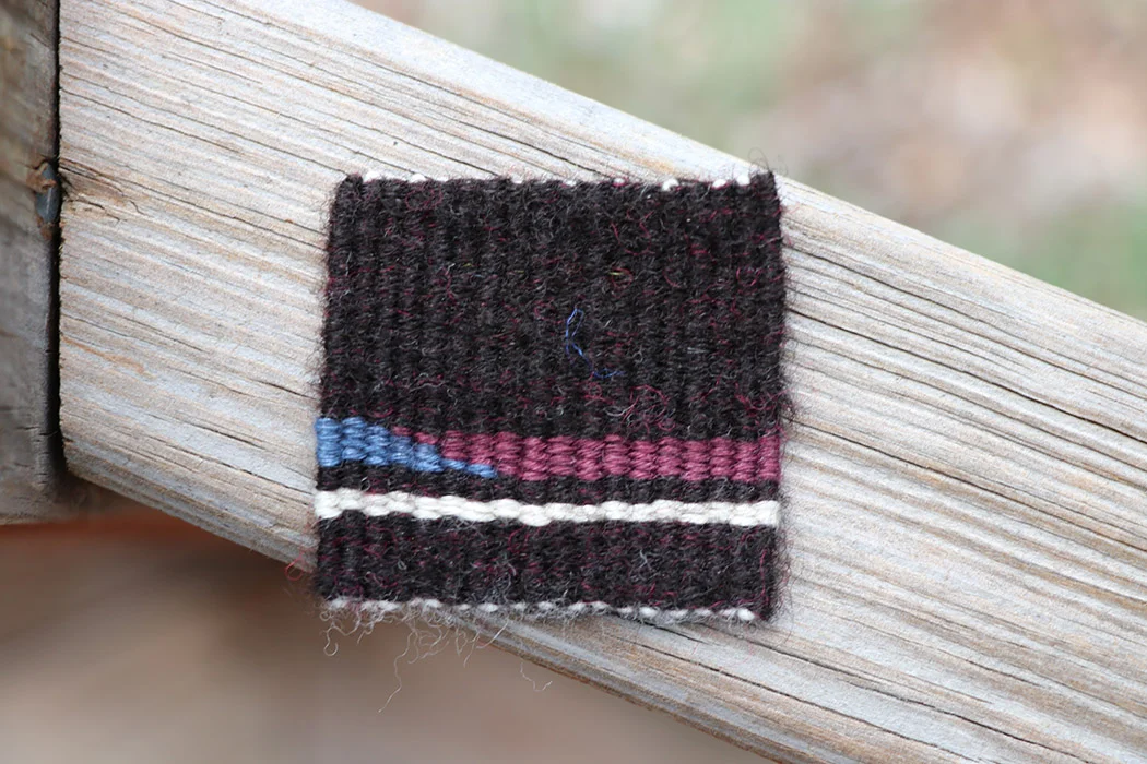 Rebecca Mezoff, handspun black CVM drum carded with a little bit of bright pink Corriedale, hemp yarn, wool warp, 2 x 2 inches