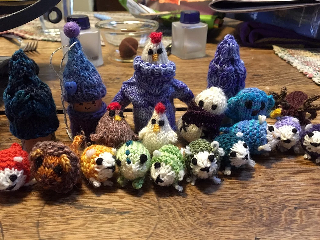 An assortment of creatures including a flock of sheep, a lion, a dinosaur, a monkey, a reindeer, and a chicken pretending the tiny sweater is a holocaust cloak for the castle keep scene from the Princess Bride. Crazy chicken!