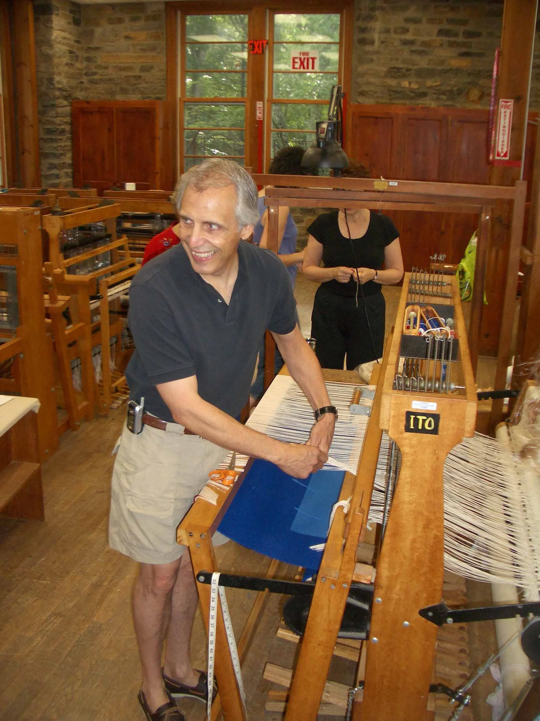 James Koehler, Penland School of Craft, 2005, cutting a Harmonic Oscillations tapestry off one of the school’s Macomber looms