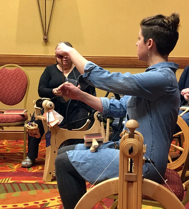 Kate Larson demonstrating separating the fibers in an Icelandic fleece