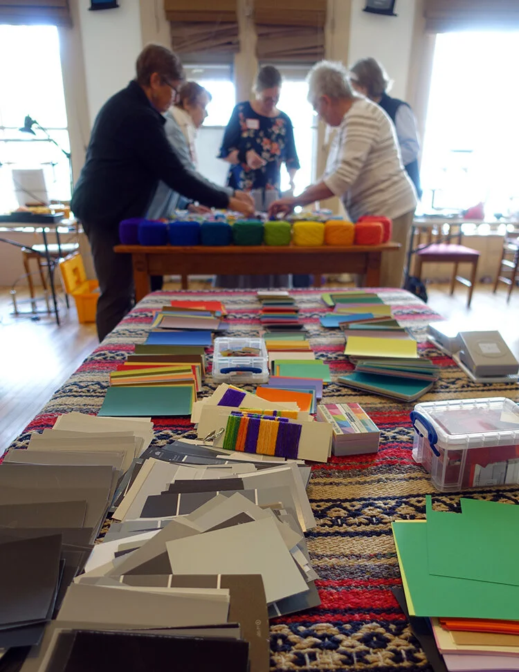 Students arranging the yarn table at the 2019 Vermont tapestry retreat.