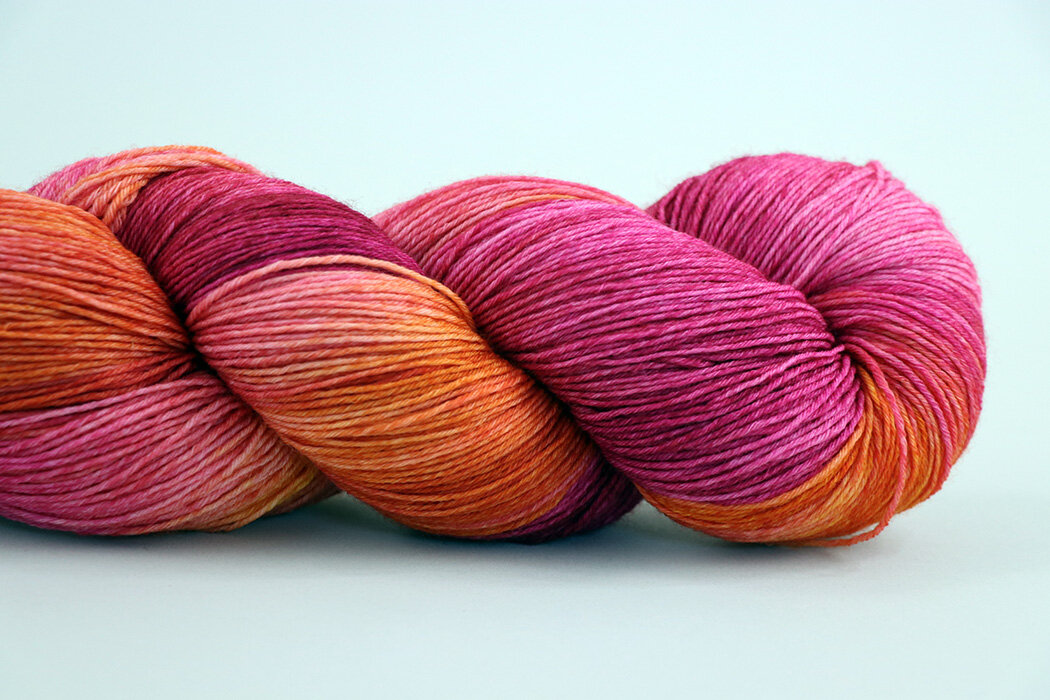 Hibiscus yarn from Julie Spins. The colorway is Hibiscus. The yarn is wool. Stress purchase which I still totally love.