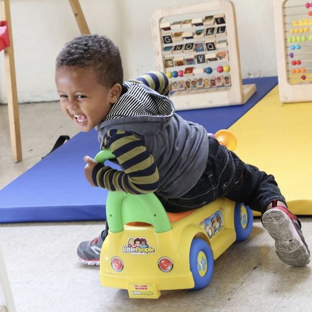 little boy on a car square.jpeg