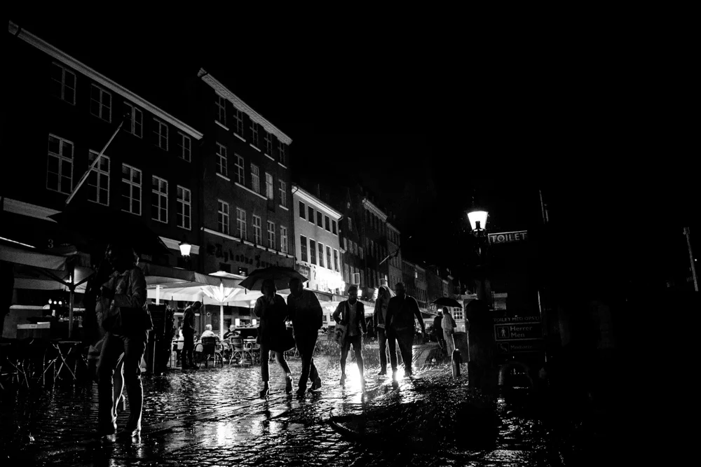 People caught in a rainstorm in Copenhagen, Denmark.