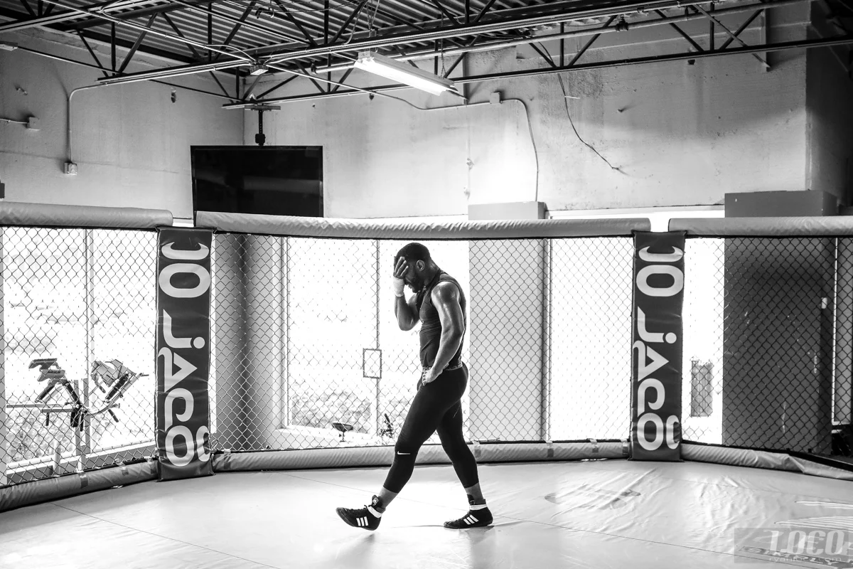 While in camp for his fight with Glover Teixeira, "Suga" Rashad Evans does a lap around the cage after practice.