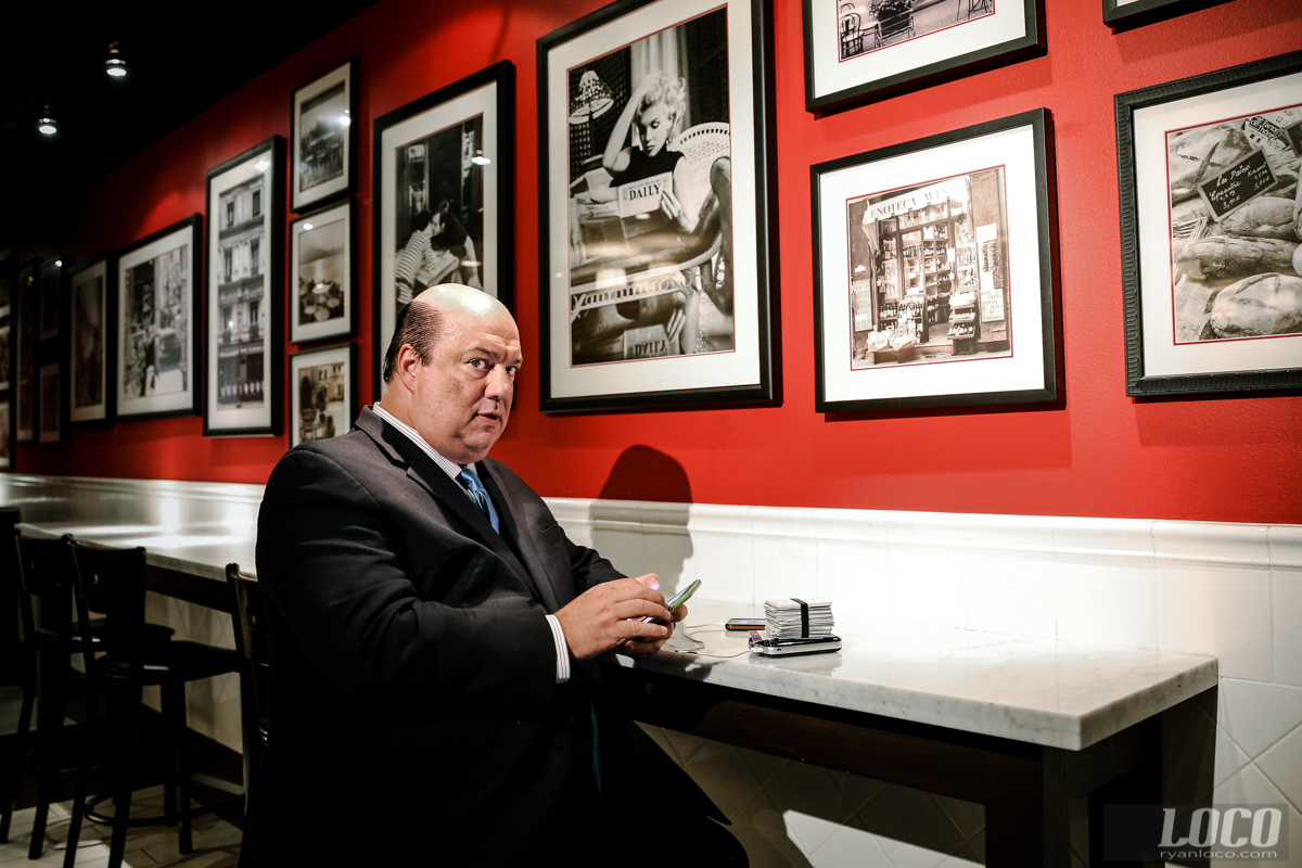 WWE star Paul Heyman caught on his phone, as usual. A Hitchcock-esque shadow looms behind him at the Hard Rock hotel in Las Vegas.