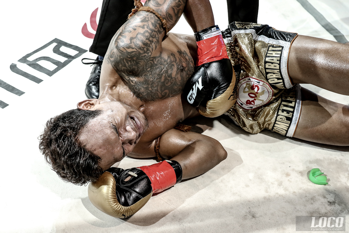 A fighter grimaces after a brutal body shot at the EM-Legend show in Chengdu, China.