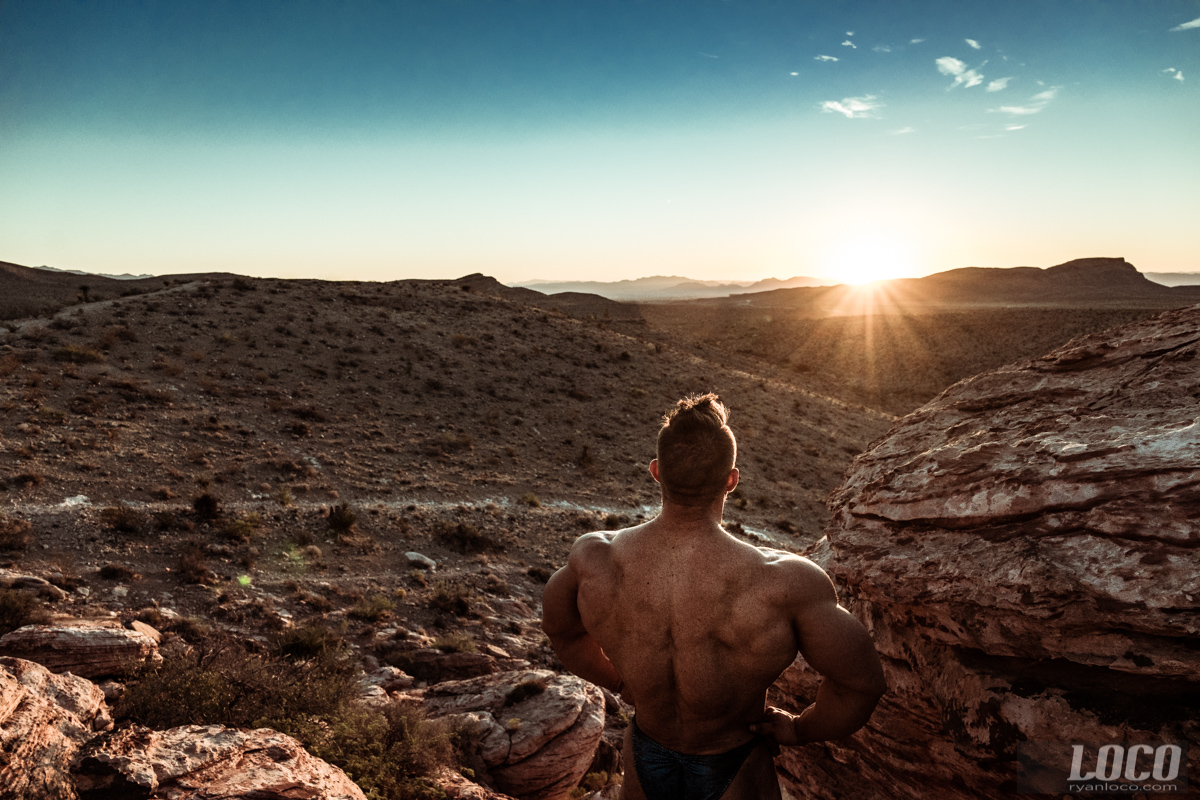 The 5 time Mr. Olympia 212 champion Flex Lewis looks out at the sunrise over Red Rock Canyon. 